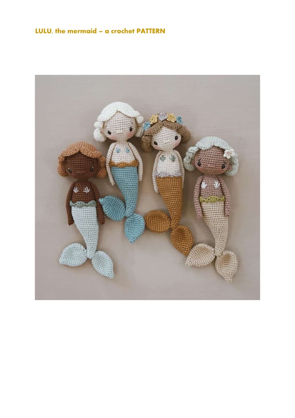 Four Lulu mermaid dolls in soft neutral colors lying together
