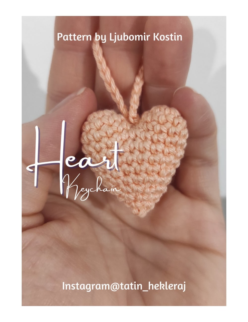 Peach crochet heart keychain held in a hand