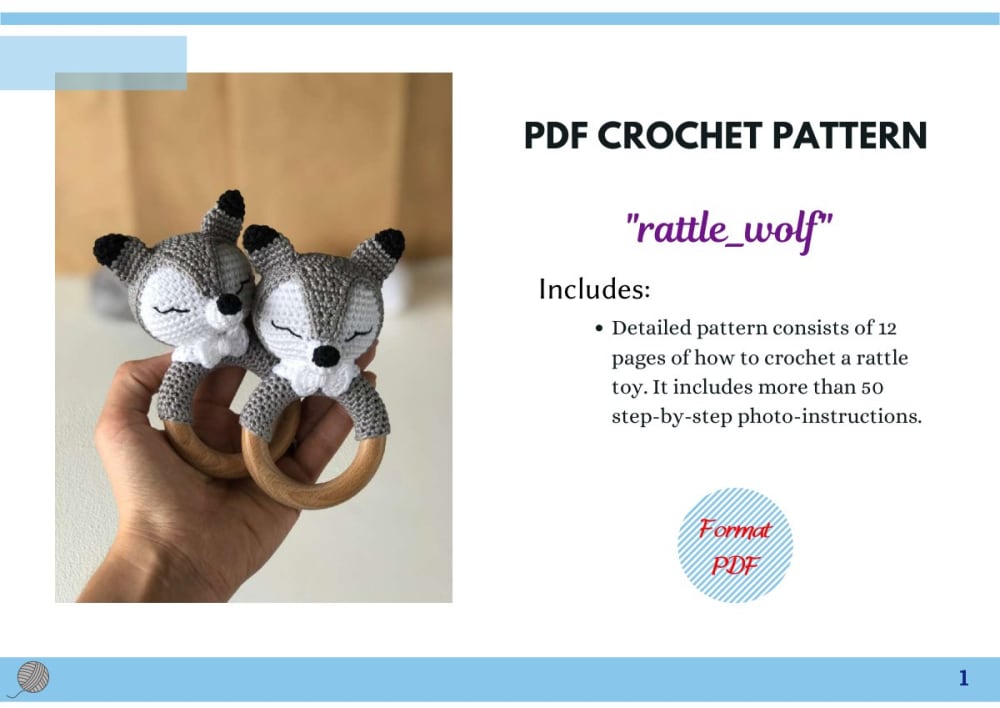 Grey and white crochet wolf head rattle on a wooden ring