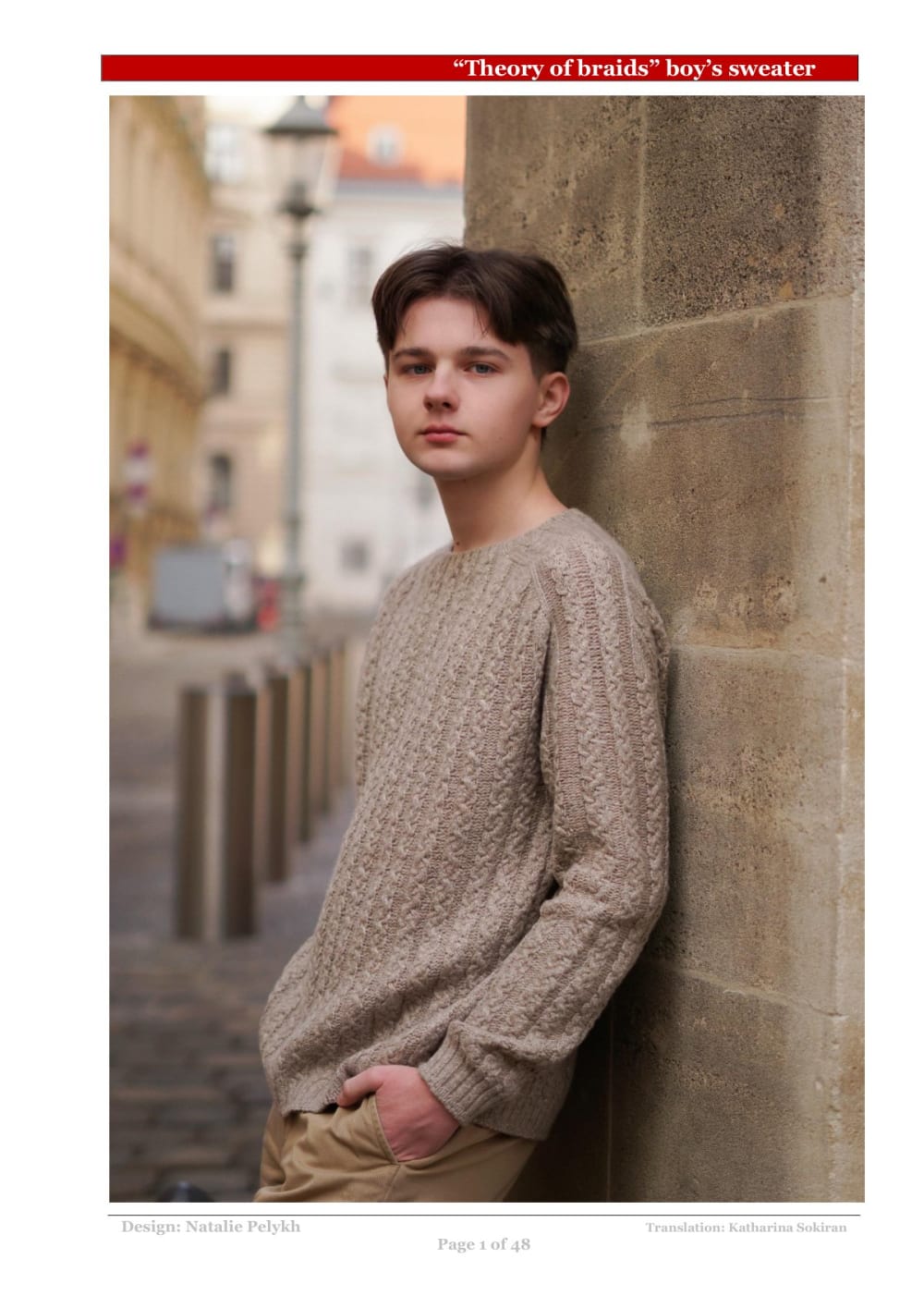 Young person wearing a beige cable knit sweater