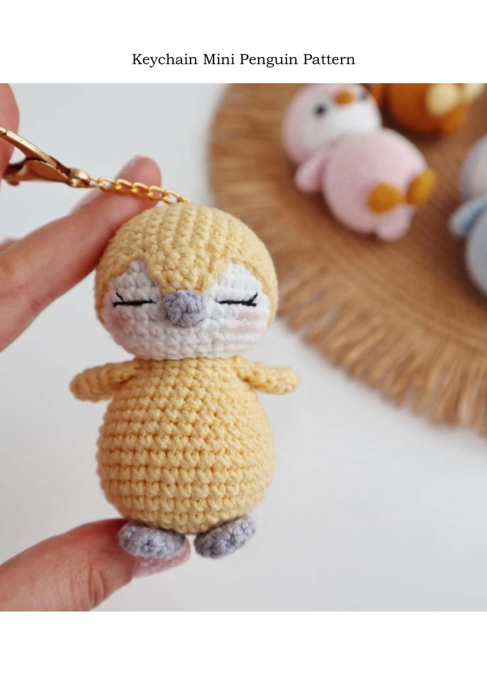 Yellow crochet mini penguin keychain held in hand