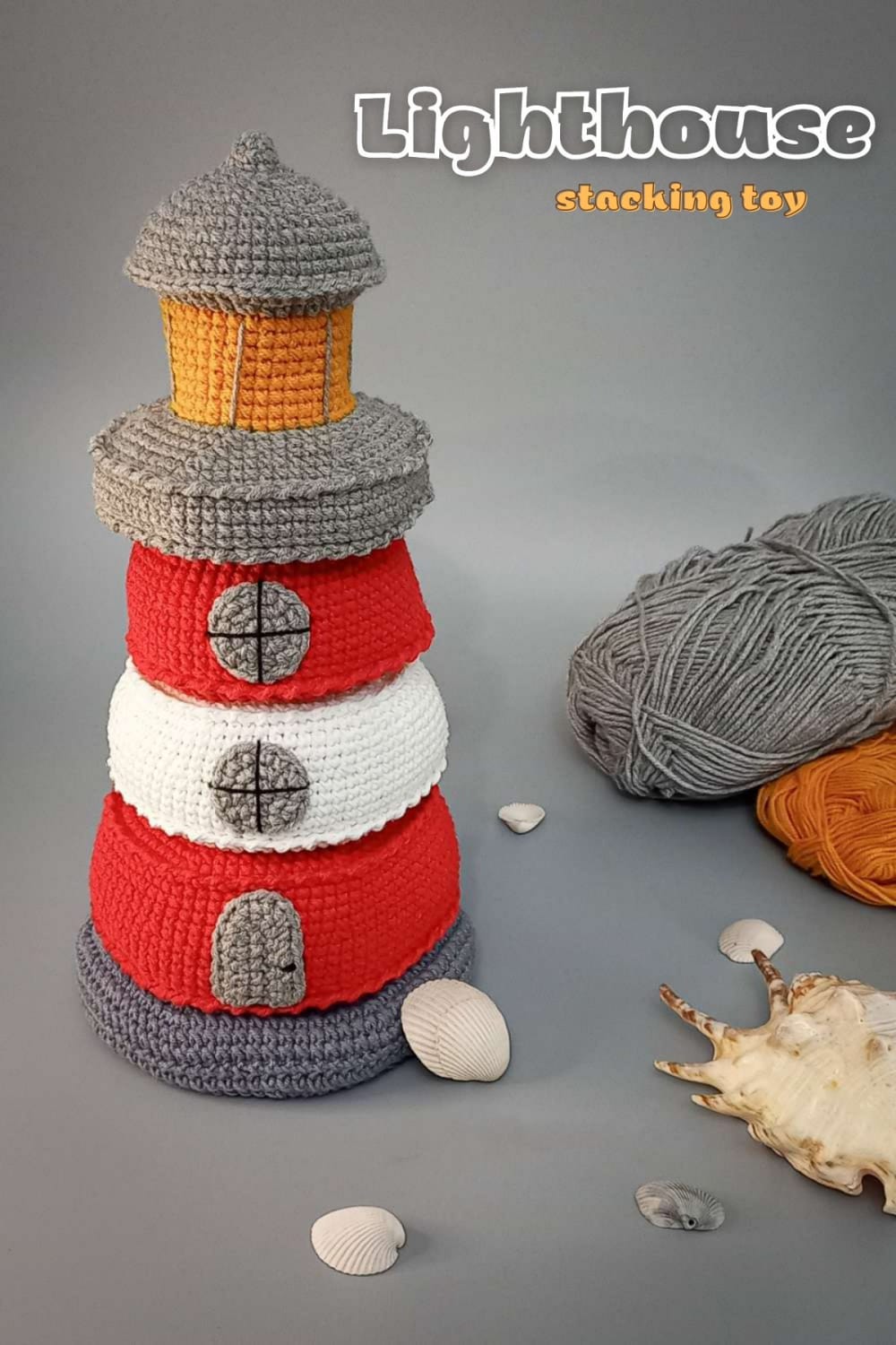 Crochet lighthouse stacking toy in red, white and grey