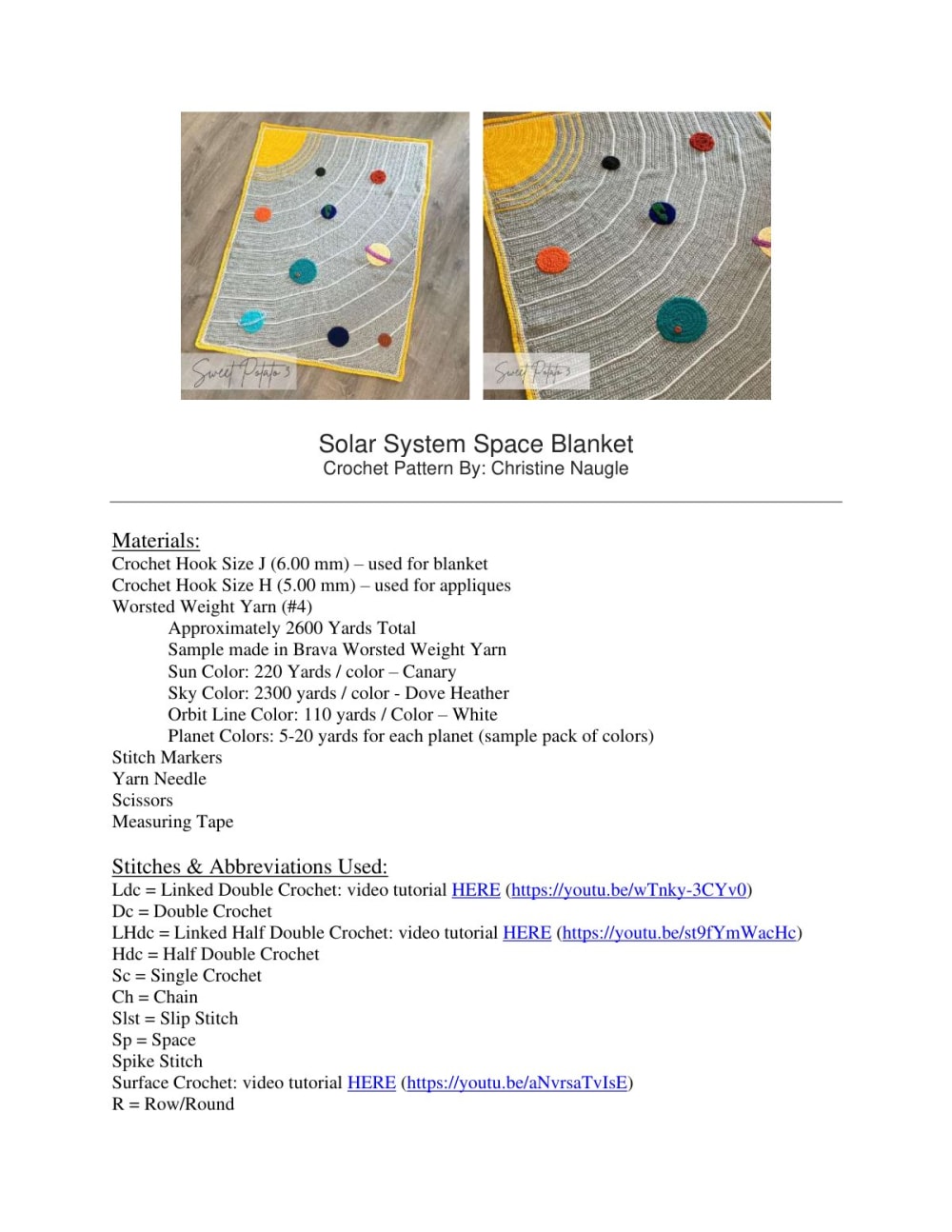 Grey crochet blanket with a yellow sun in the corner, white orbit lines and colorful planets