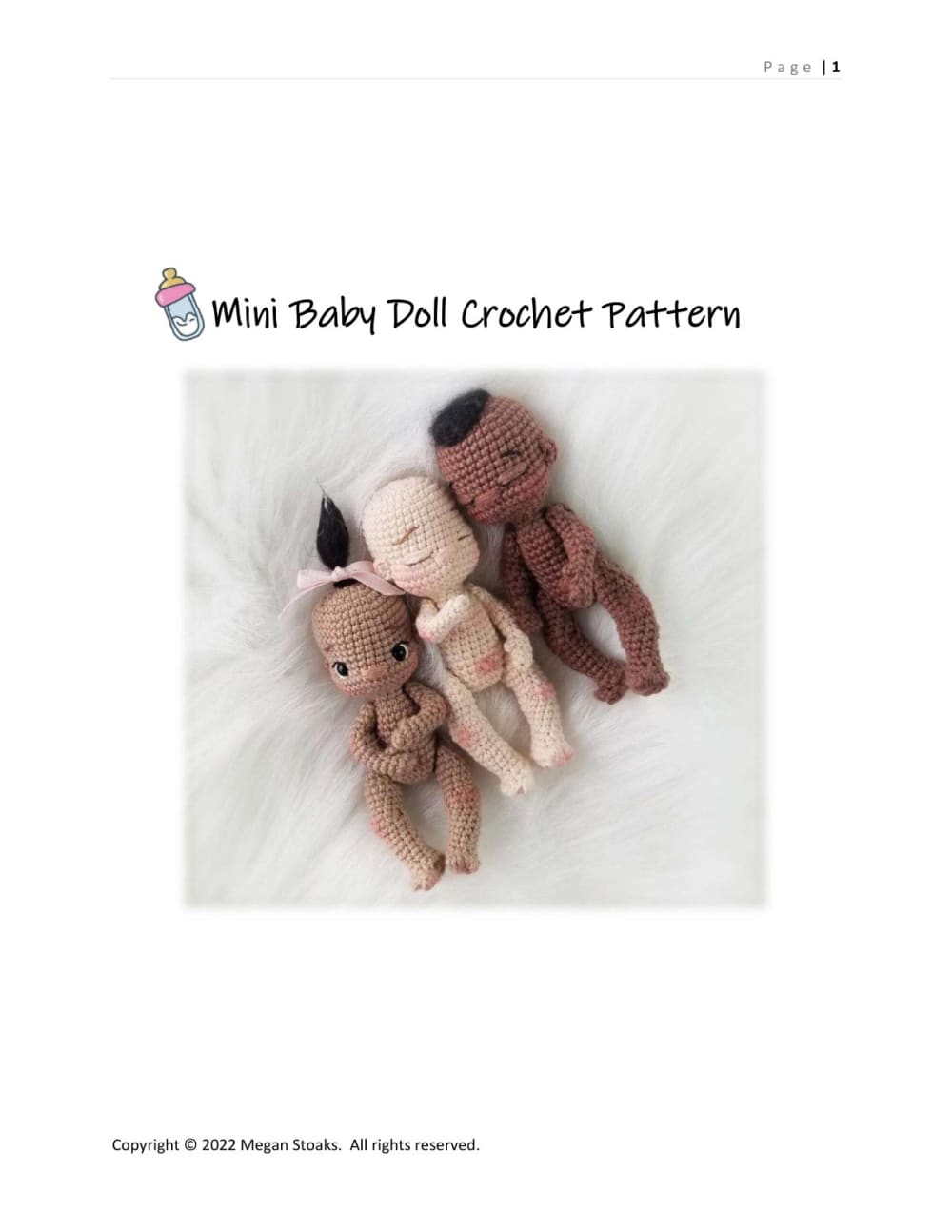 Two mini crochet baby dolls in different skin tones lying together