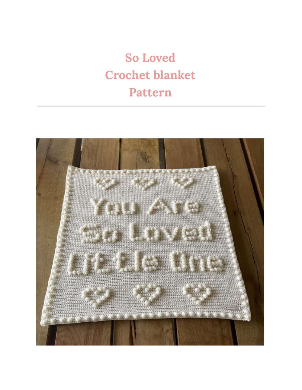 Cream crochet baby blanket with puff stitch words and hearts