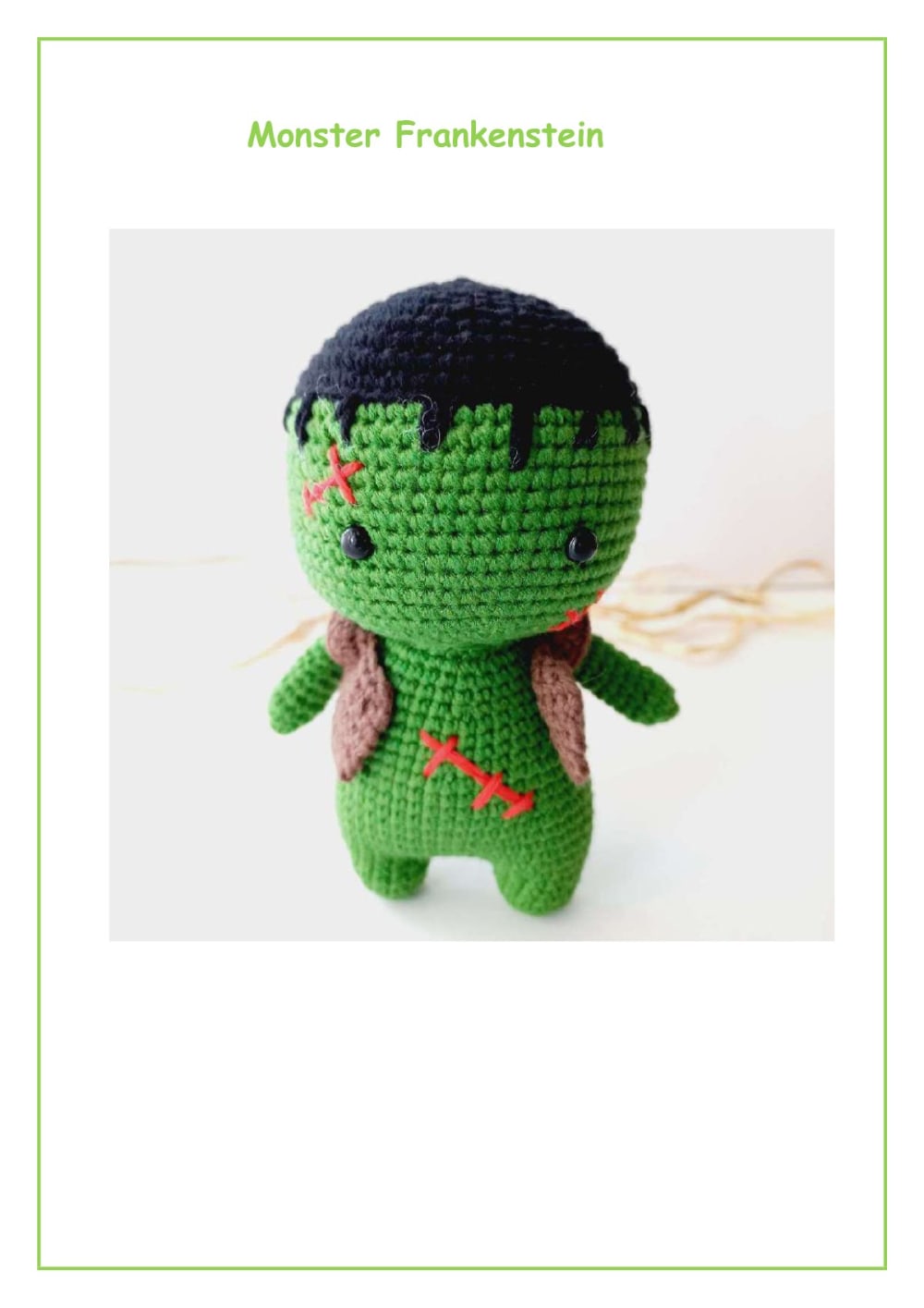 Green crochet Frankenstein monster with black hair and a brown sweater