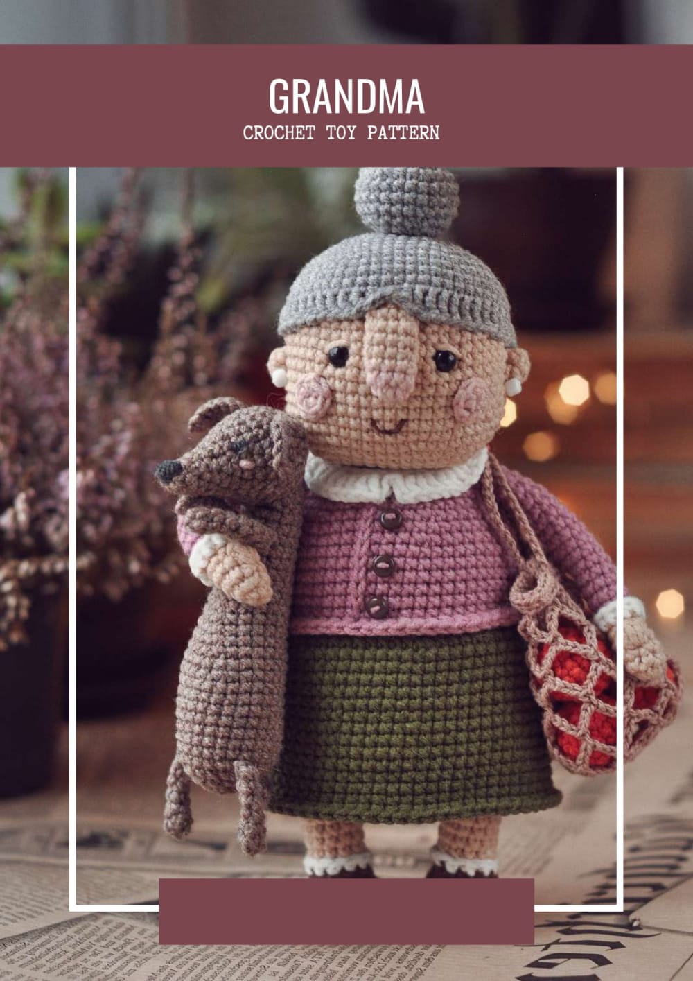 Crochet grandma doll with grey hair, pink cardigan, green skirt and a string bag