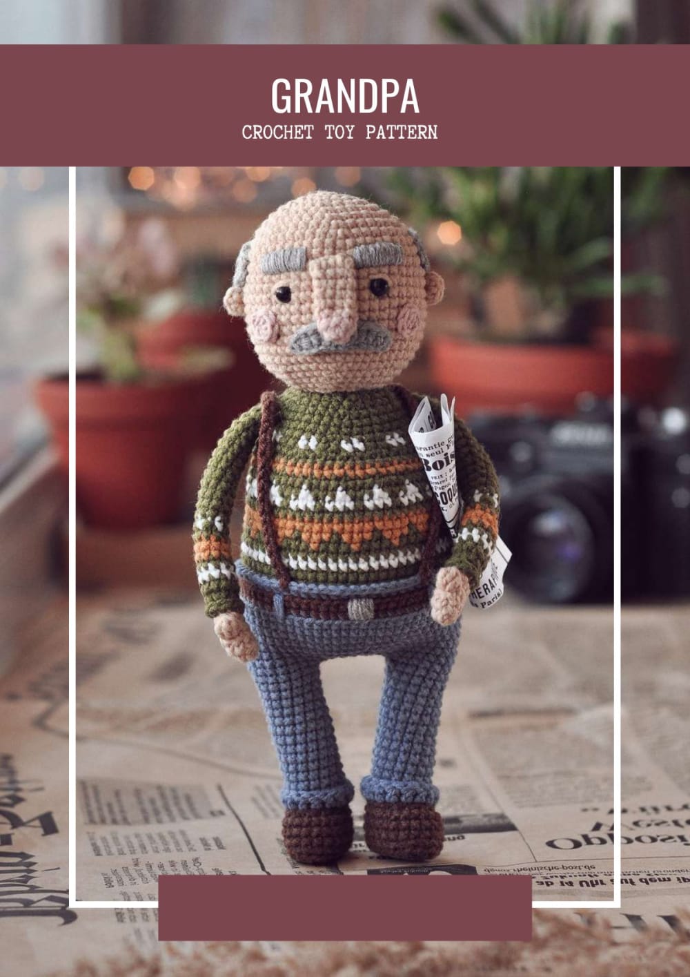 Crochet grandpa doll with grey hair, moustache, green patterned sweater and blue trousers