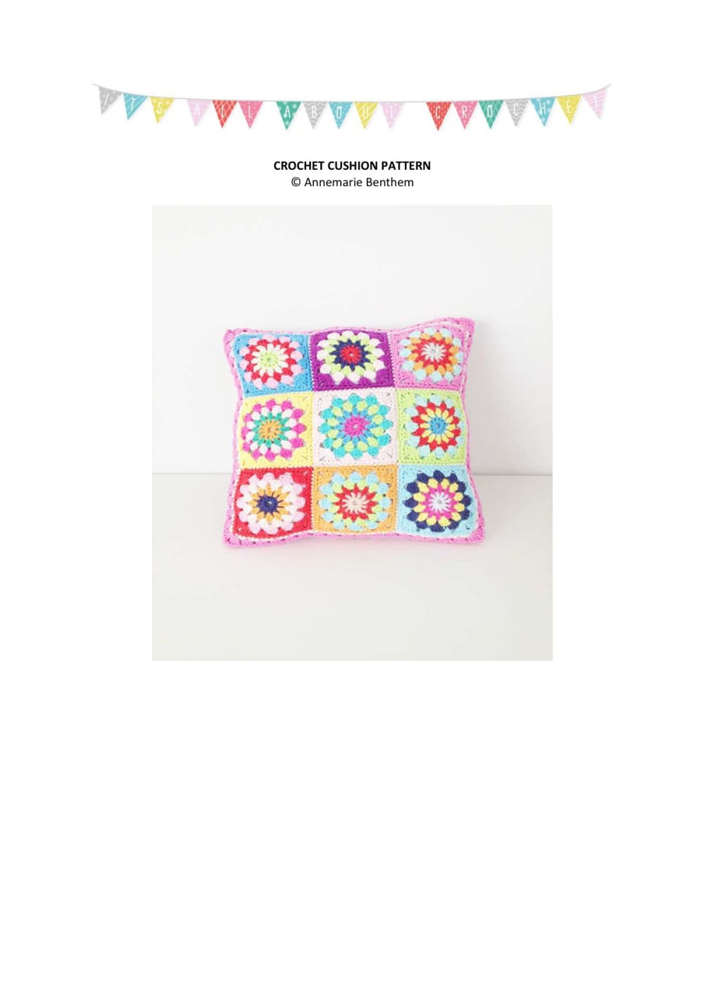 Crochet cushion with white-bordered granny squares in pink, red and purple