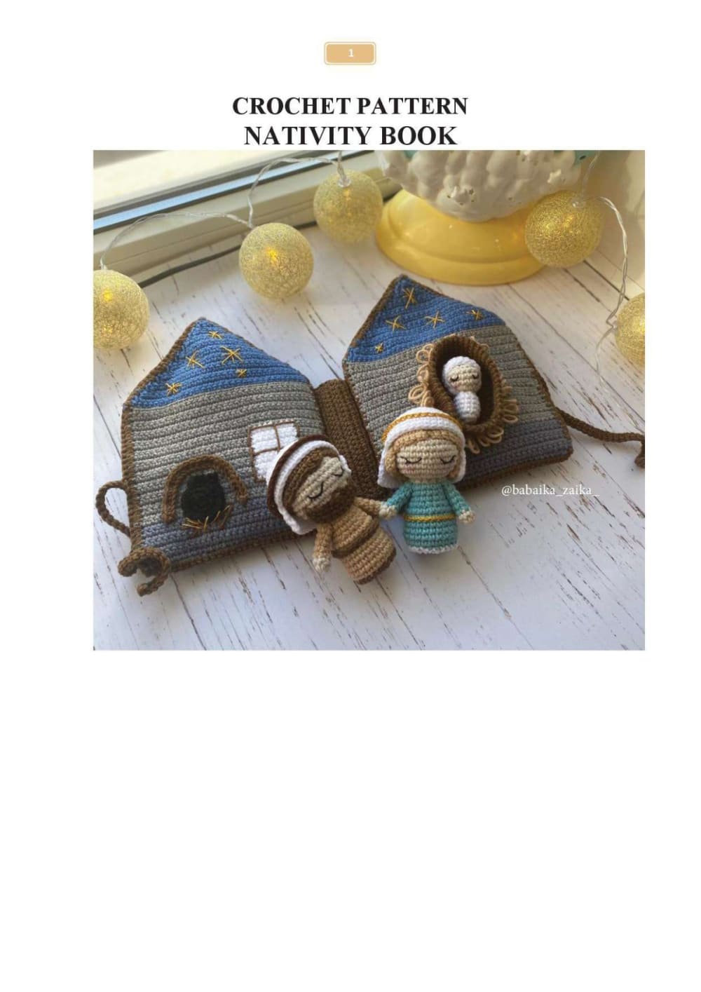 Crochet nativity book shaped like a house with small holy family dolls
