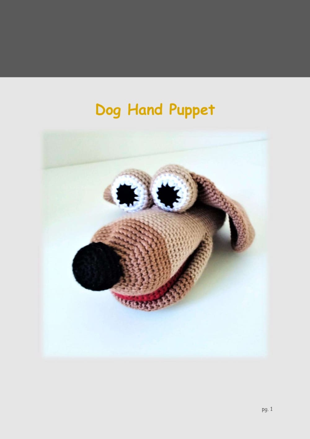 Crochet dog hand puppet with floppy brown ears, big eyes and a black nose
