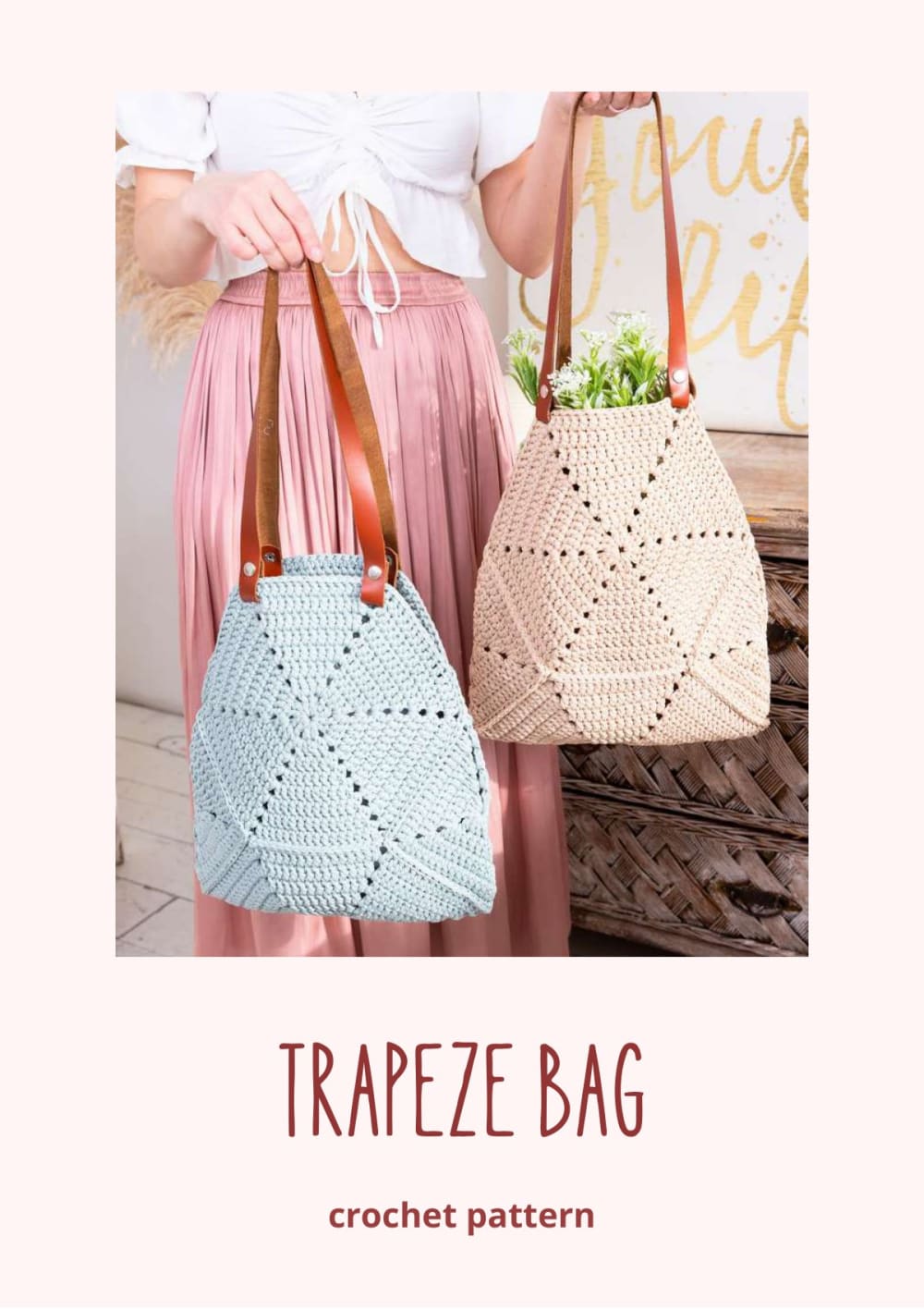 Woman holding beige and blue crochet trapeze bags with leather handles