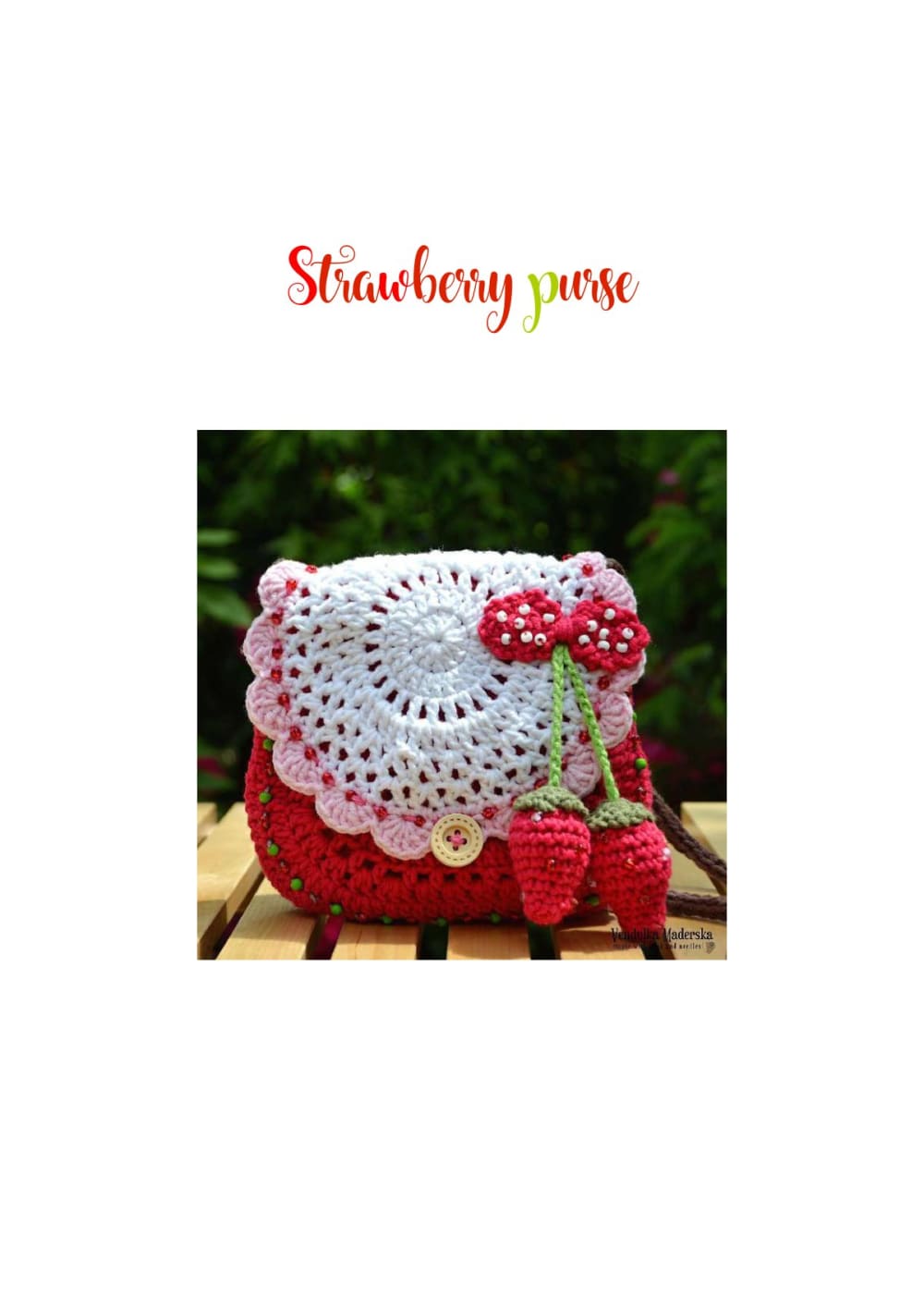 Red crochet strawberry purse with a white lace flap and little strawberries