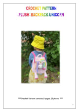 Child wearing a pink plush crochet unicorn backpack with a rainbow mane and a yellow bucket hat