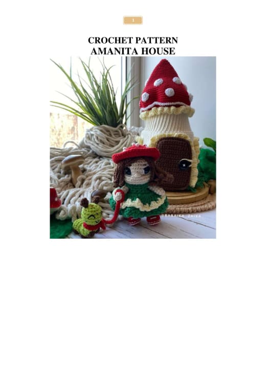 Crochet red and white amanita mushroom house with a green-dressed doll and a small caterpillar