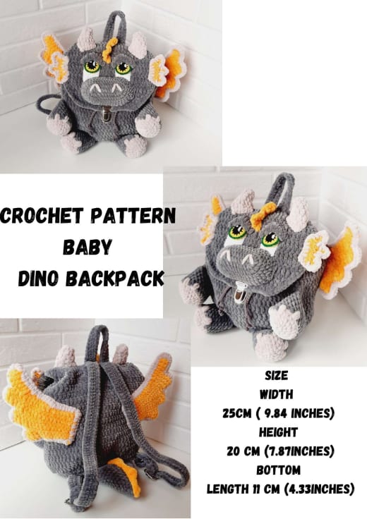 Grey plush crochet dino backpack with orange wings, green eyes and a metal clasp