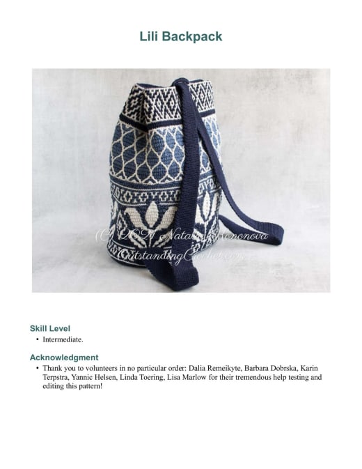 Navy blue and white overlay mosaic crochet backpack with a leaf and diamond pattern and a shoulder strap