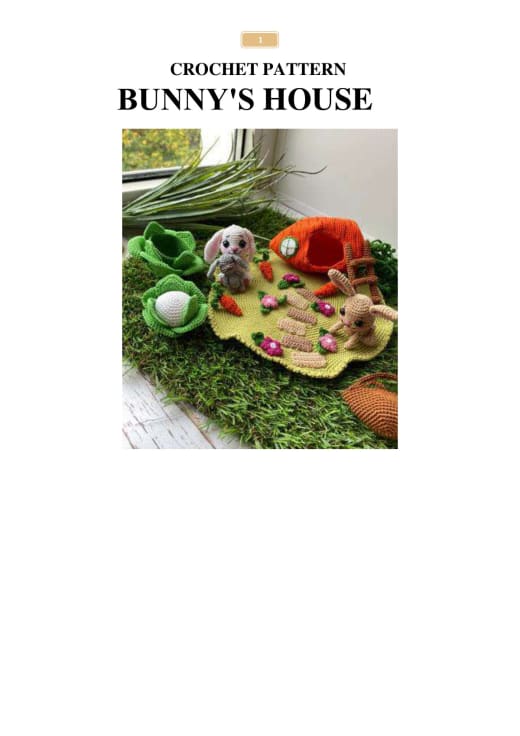 Tiny crochet bunnies, an orange carrot house and a green cabbage on a flower meadow base