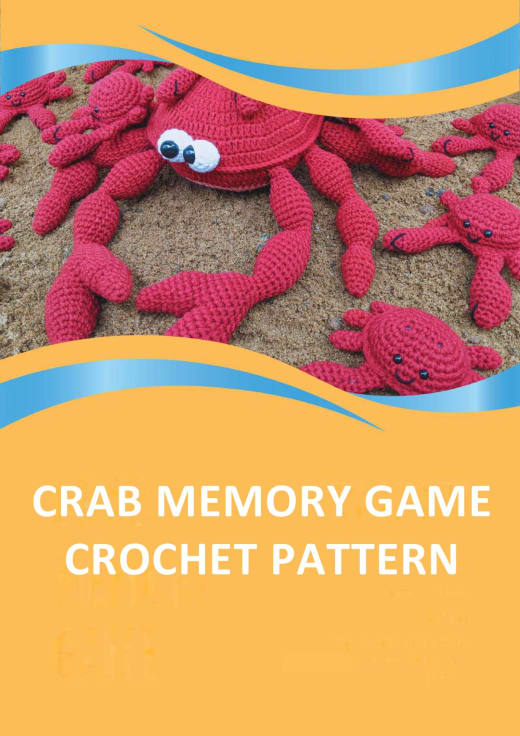Red crochet mother crab with ten baby crabs on sand, with colored matching shapes on their backs
