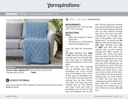 Blue diamond lattice blanket draped over a gray sofa, with the instructions and materials beside it