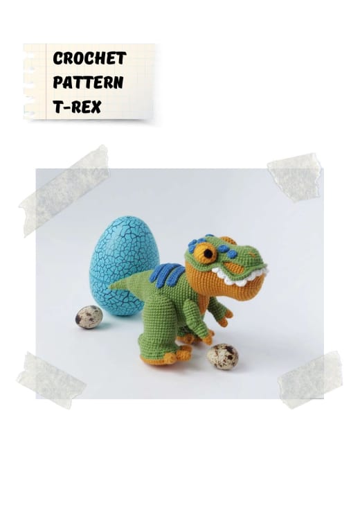 Green and orange crochet T-Rex with a blue spotted dinosaur egg and small speckled eggs