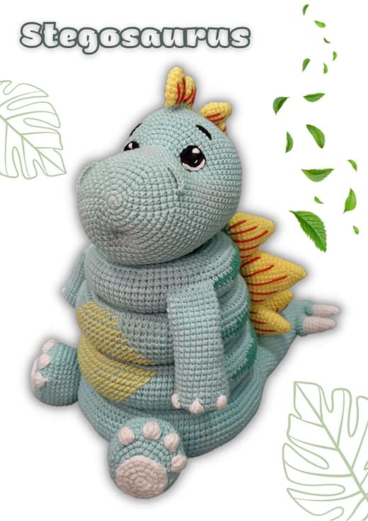 Light blue and green crochet stegosaurus stacking toy with yellow plates and three rings