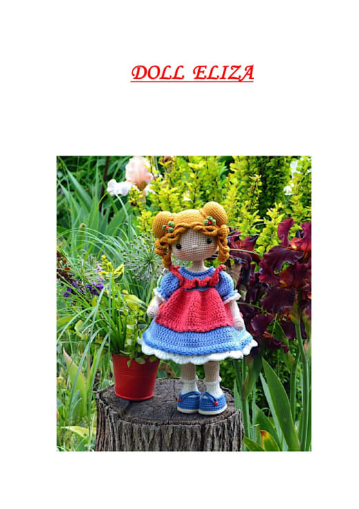 Amigurumi doll with golden curly pigtails, a red and blue ruffle dress and blue shoes standing near flowers