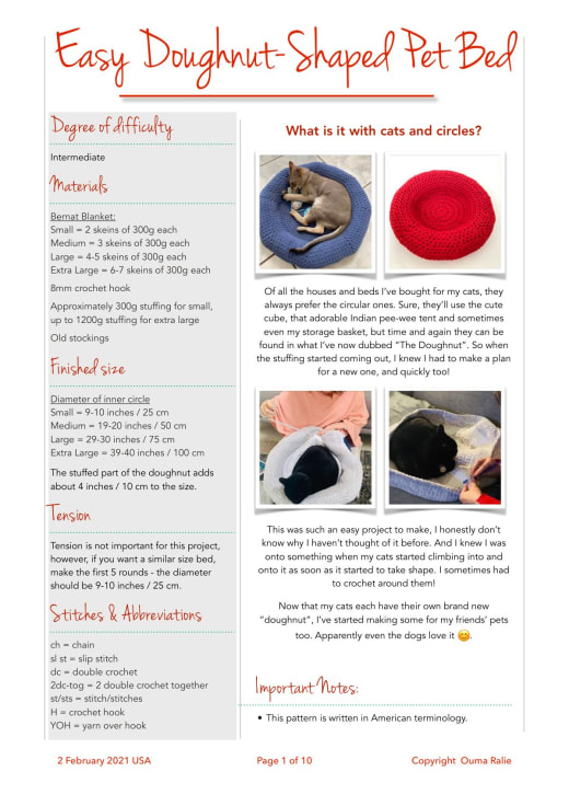 Red round crochet doughnut-shaped pet bed with a cat sleeping in it