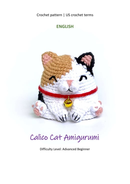 Calico cat amigurumi with a red collar and a golden bell