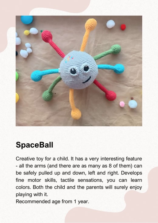 Grey crochet ball with a smiling face and red, green, yellow and blue arms