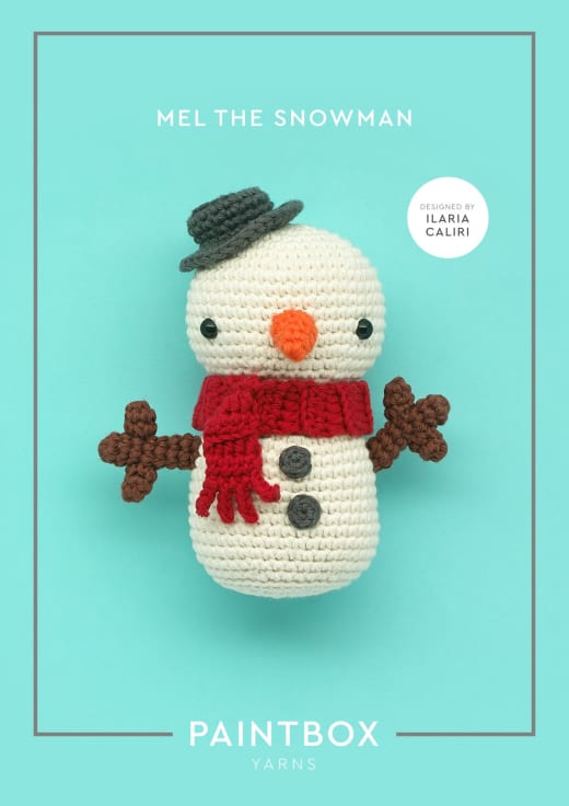 Crochet snowman with a grey hat, an orange nose, a red scarf and brown stick arms