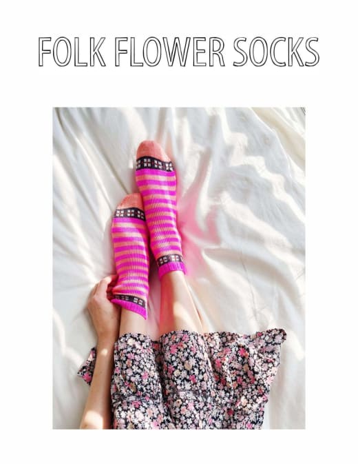 Pink and green striped socks with a flower colorwork band worn on feet