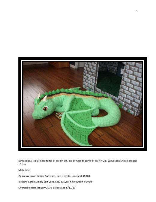 Huge green crochet dragon lying with wings spread