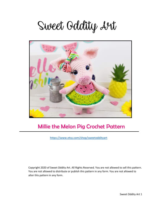 Millie the pink pig amigurumi wearing a watermelon hat next to a pineapple