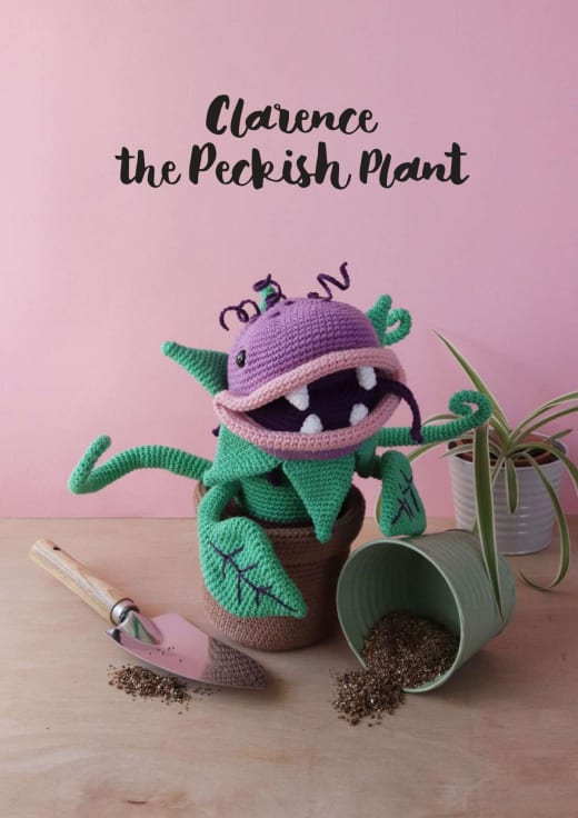 Crochet carnivorous plant with a purple head, open mouth and green leaves in a brown pot