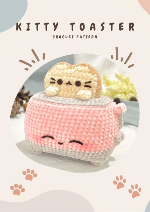 Pink crochet toaster with a cat-faced slice of bread