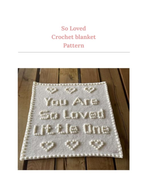 Cream crochet baby blanket with puff stitch words and hearts