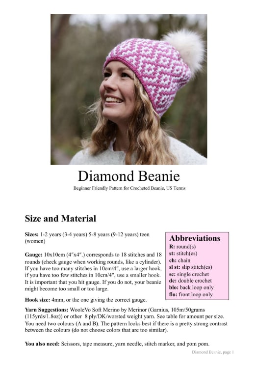 Woman wearing a pink and white diamond mosaic beanie with a pom pom