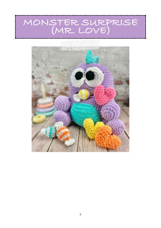 Lilac plush monster with big eyes, a turquoise belly and a heart