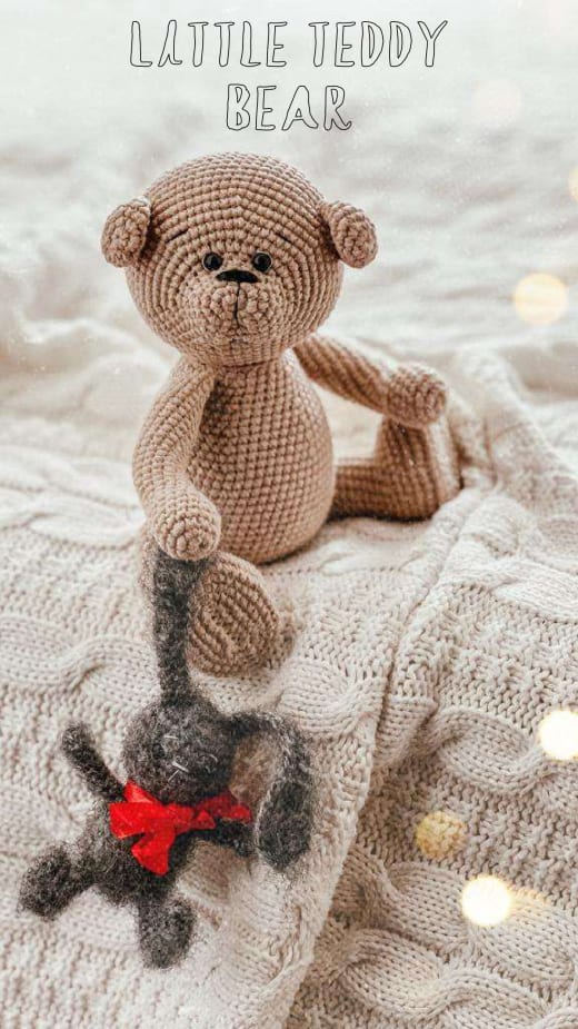 Beige crochet teddy bear sitting on a knitted blanket