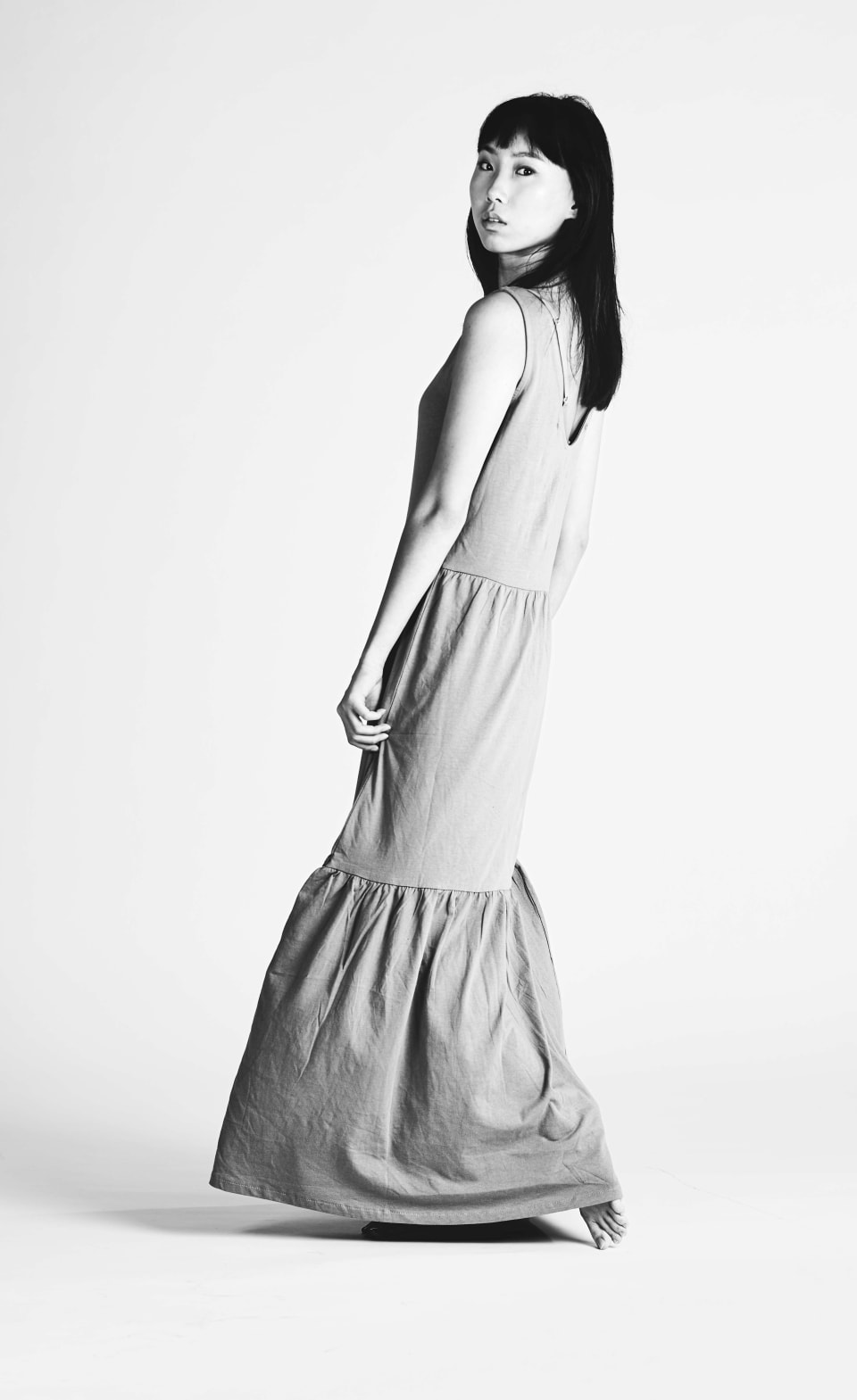 Black and white portrait, standing, grey backdrop