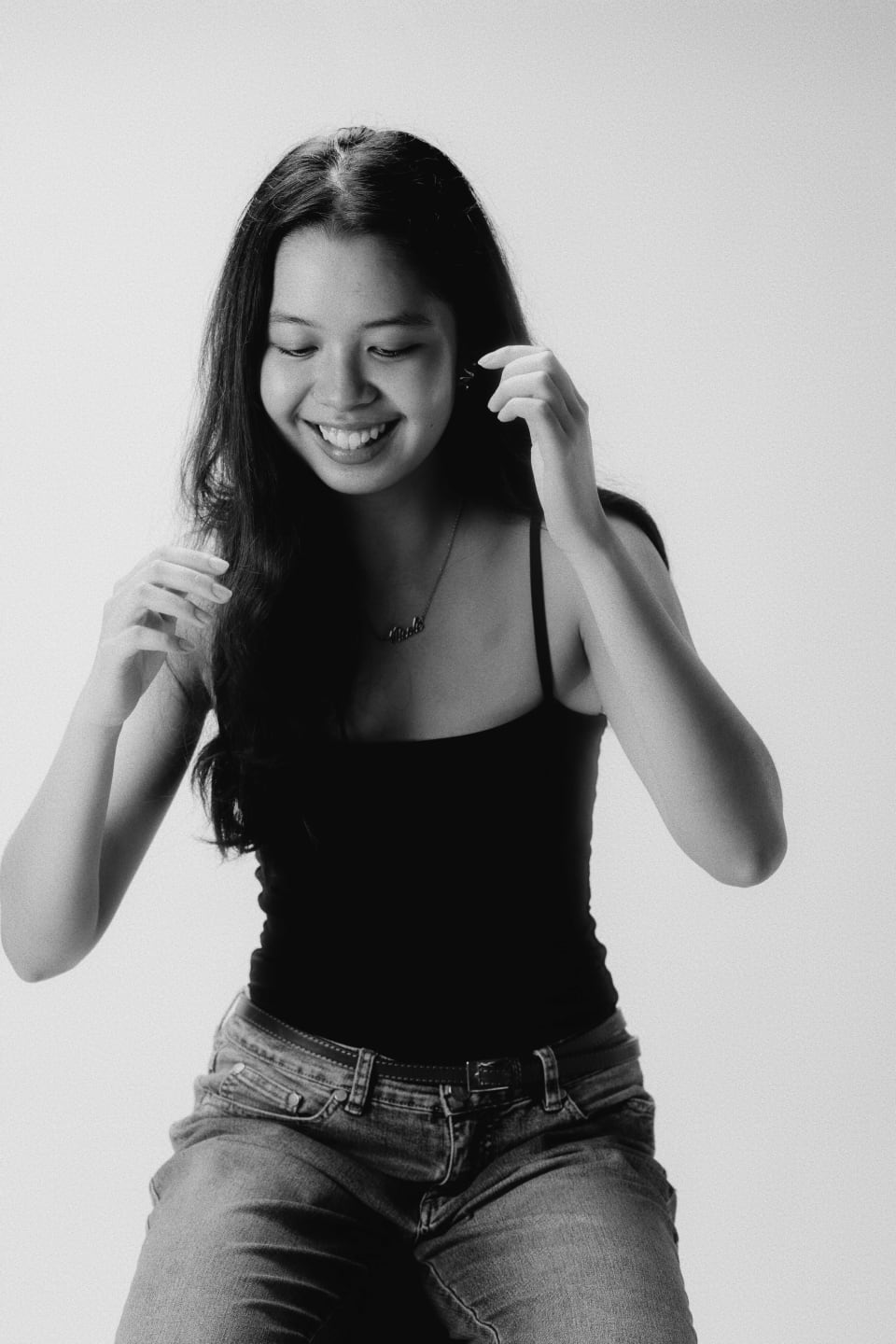 Seated portrait on a stool, open smile