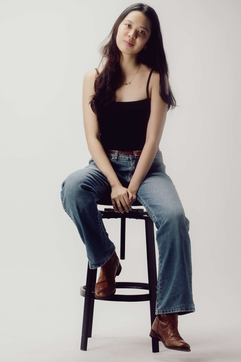 Seated portrait on a stool, denim, warm studio light