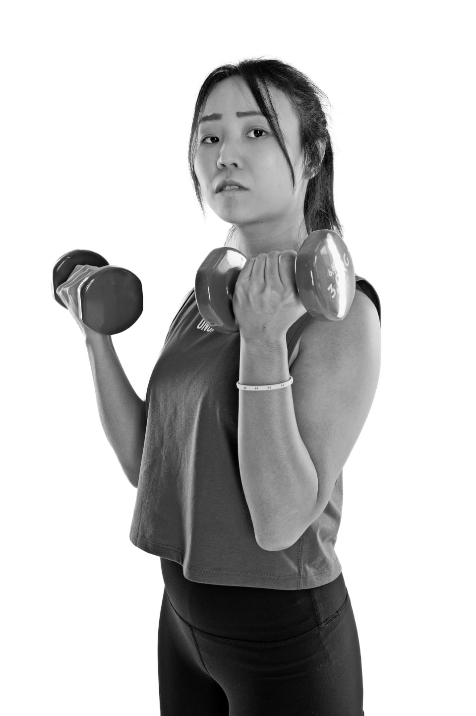 Bicep curl with a dumbbell, studio portrait