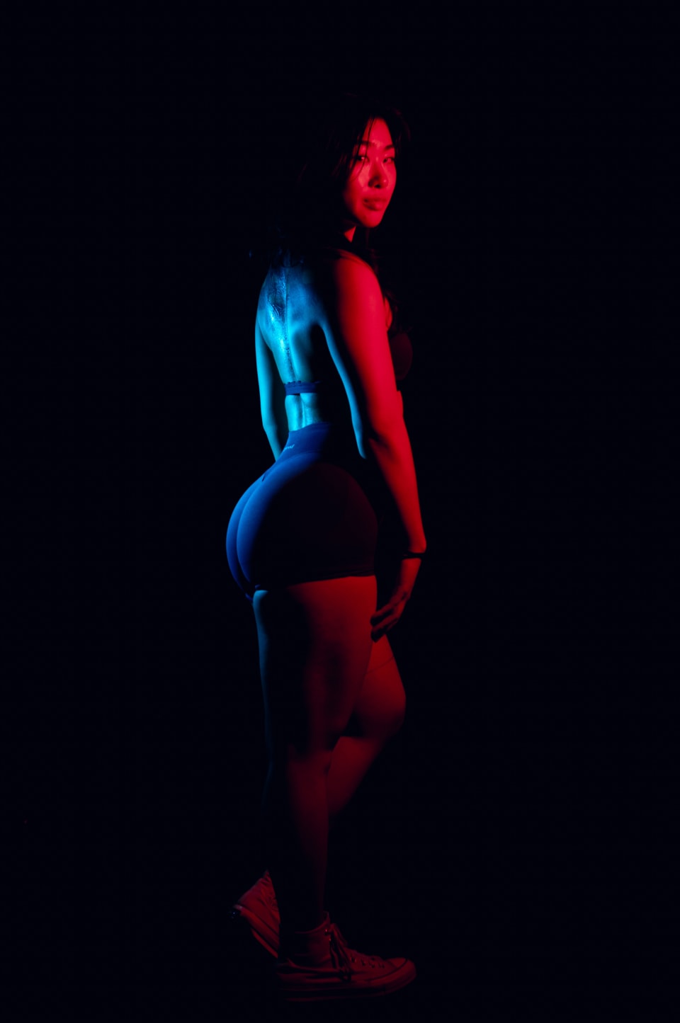 Rear view portrait under red and blue split lighting