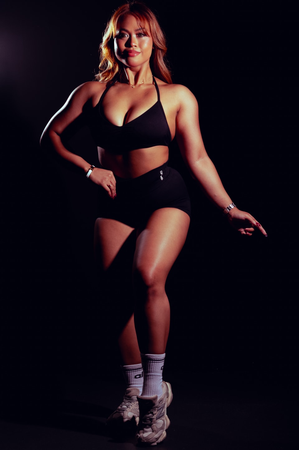 Playful standing pose, warm studio light