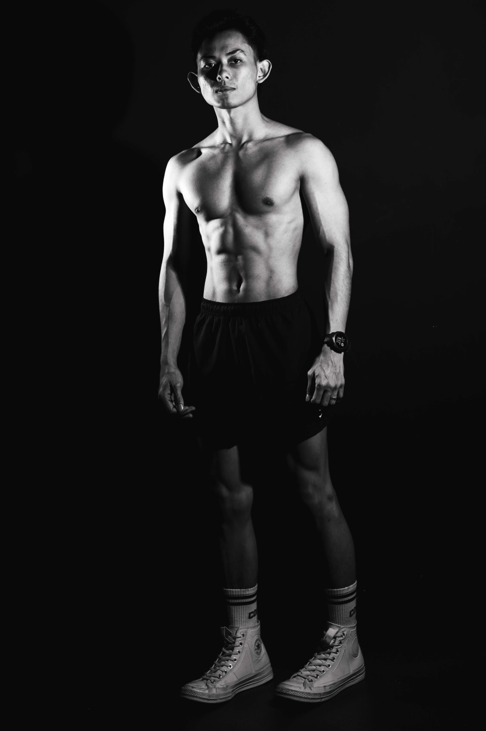 Standing portrait, athletic build, black and white studio