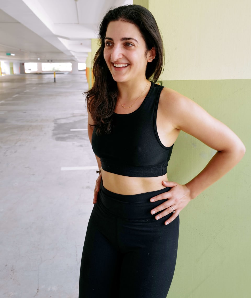 Standing portrait, smiling, green wall backdrop