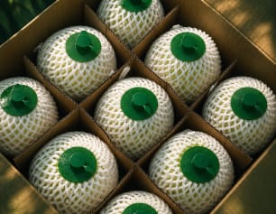 Fresh husked coconuts packed in a wooden crate ready for export