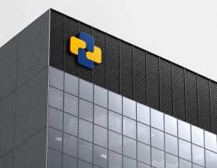 Investment firm logo on the top of a glass office building